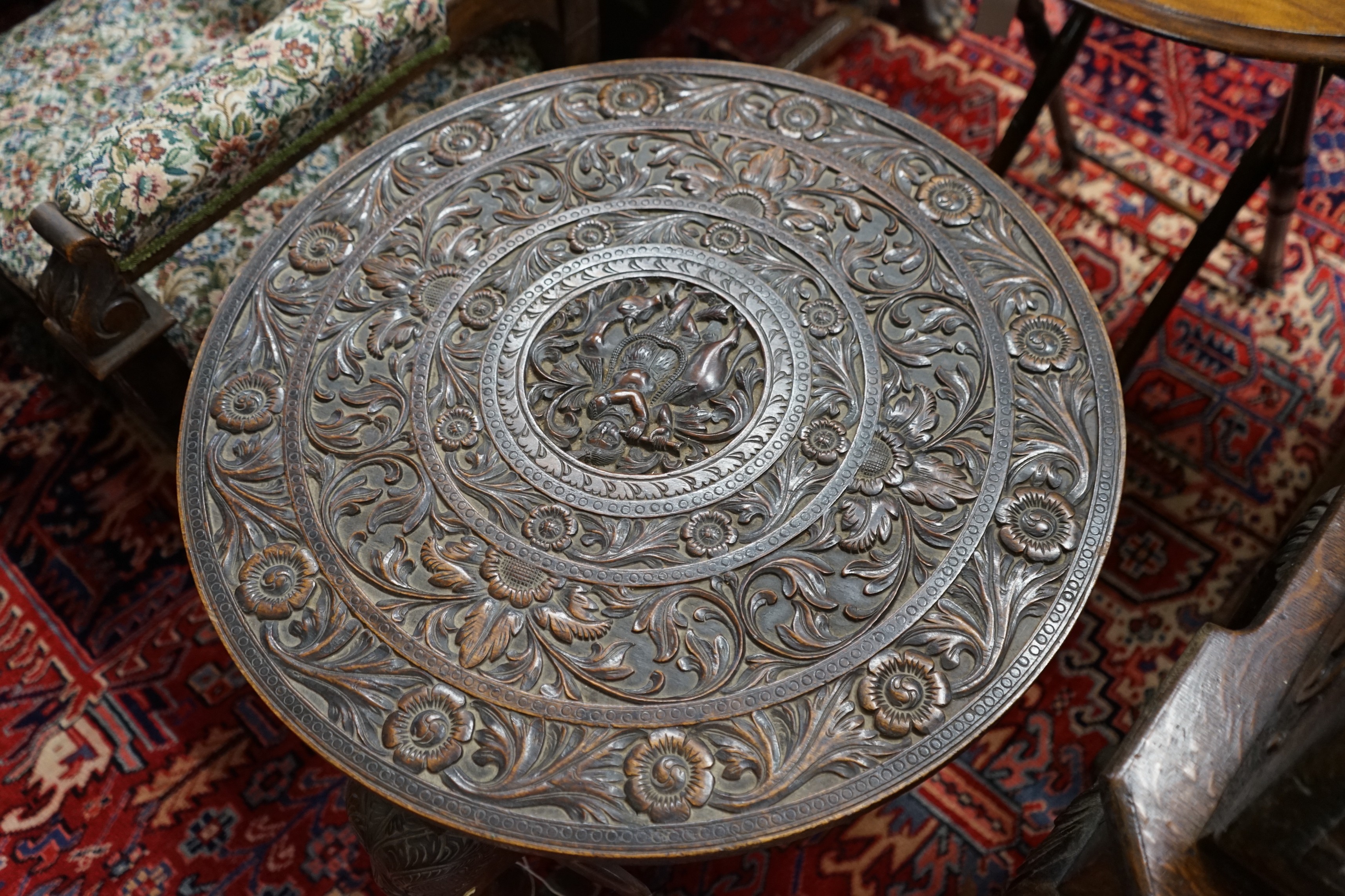 An Indian circular carved hardwood occasional table, diameter 60cm, height 63cm